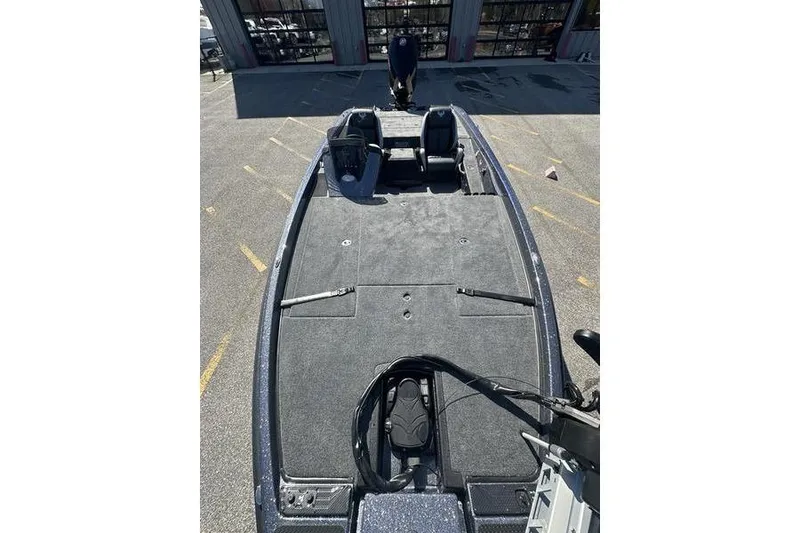 Slide: The Image of 2026 Phoenix 721 ZXL boat with spacious deck and seating, parked outdoors. - 8