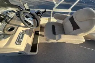 Slide: The Image of 2017 Sun Tracker Party Barge 24 DLX helm with steering wheel and captain's chair. - 11