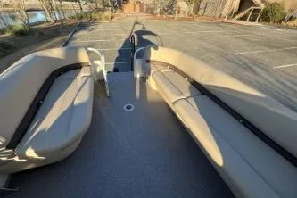 Slide: The Image of 2017 Sun Tracker Party Barge 24 DLX with spacious seating in a parking lot. - 5