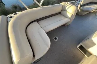 Slide: The Image of 2017 Sun Tracker Party Barge 24 DLX with beige seating and cup holders. - 7