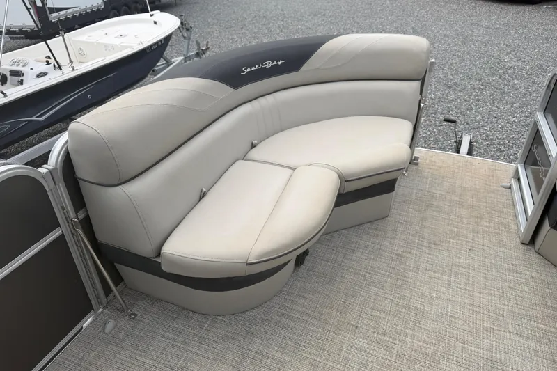 Slide: The Image of 2021 South Bay 222RS LE pontoon boat with beige seating and carpeted deck. - 13