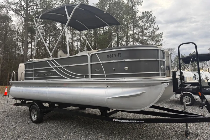 Slide: The Image of 2021 South Bay 222RS LE pontoon boat on trailer, parked outdoors. - 4