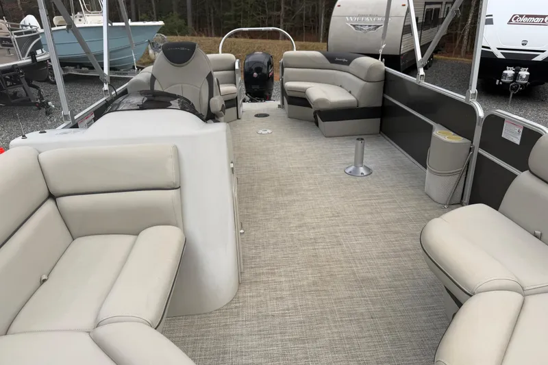 Slide: The Image of 2021 South Bay 222RS LE pontoon boat interior with beige seating and spacious layout. - 5