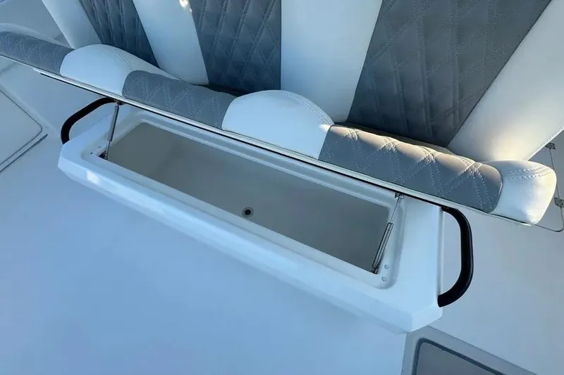 Slide: The Image of 2022 Invincible 35 Catamaran seat with storage compartment open, showcasing luxury design. - 14