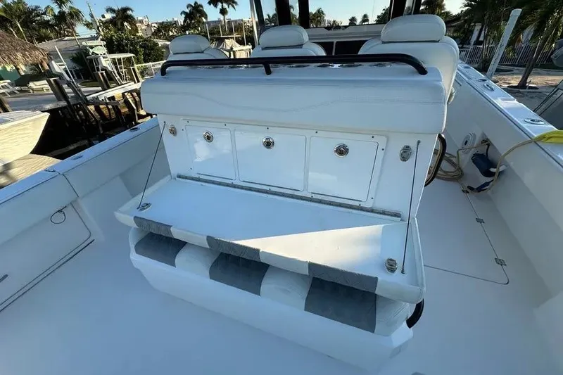 Slide: The Image of 2022 Invincible 35 Catamaran interior with white seating and storage compartments. - 15