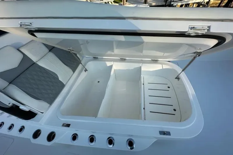 Slide: The Image of Open storage compartment on 2022 Invincible 35 Catamaran with cushioned seating. - 19