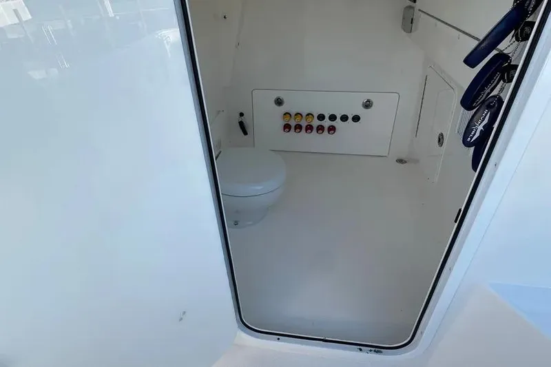 Slide: The Image of 2022 Invincible 35 Catamaran interior with toilet and control panel. - 20