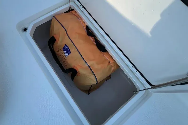 Slide: The Image of Storage compartment on 2022 Invincible 35 Catamaran with orange bag inside. - 22