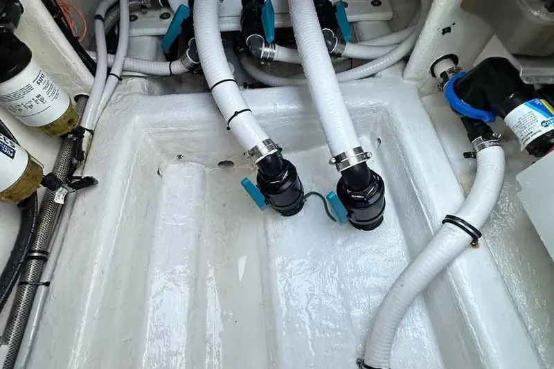 Slide: The Image of Engine compartment of 2022 Invincible 35 Catamaran with hoses and fittings. - 27