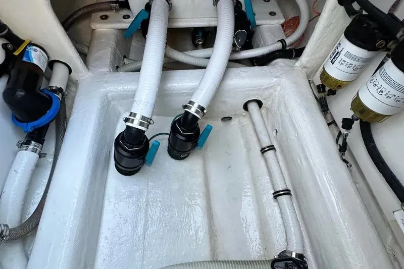 Slide: The Image of Engine compartment of 2022 Invincible 35 Catamaran, showcasing hoses and filters. - 30