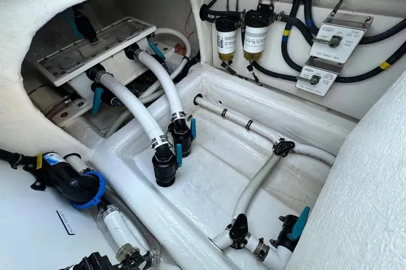 Slide: The Image of Engine compartment of 2022 Invincible 35 Catamaran with hoses and filters visible. - 31