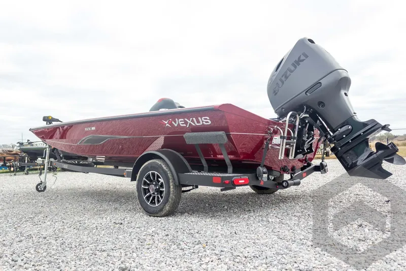Slide: The Image of 2026 Vexus Defender 189 boat with Suzuki outboard motor on gravel. - 11