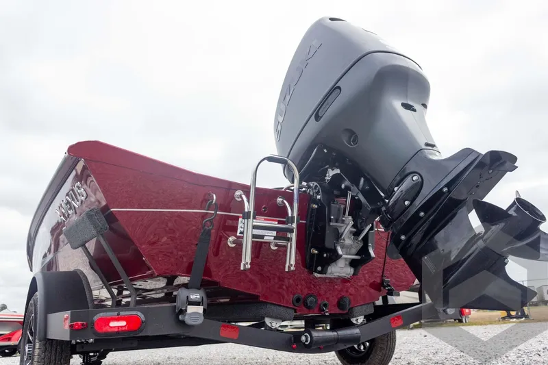 Slide: The Image of 2026 Vexus Defender 189 boat with Suzuki outboard motor, rear view on trailer. - 12
