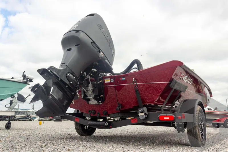 Slide: The Image of 2026 Vexus Defender 189 boat with powerful outboard motor, parked on gravel. - 13