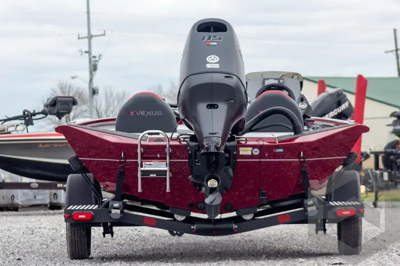 Slide: The Image of 2026 Vexus Defender 189 boat, rear view, featuring powerful outboard motor and sleek design. - 3