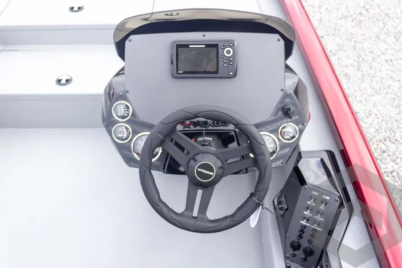 Slide: The Image of 2026 Vexus Defender 189 boat dashboard with steering wheel and control panel. - 35