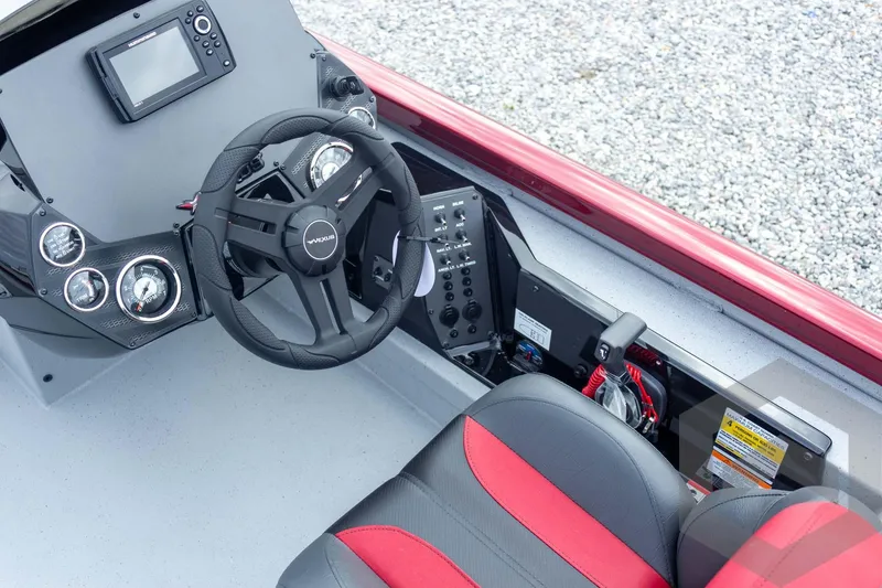 Slide: The Image of 2026 Vexus Defender 189 boat cockpit with steering wheel and control panel. - 36