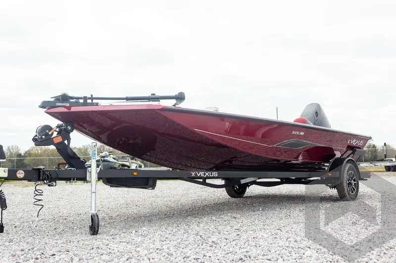 Slide: The Image of 2026 Vexus Defender 189 boat on trailer, displayed outdoors on gravel. - 5