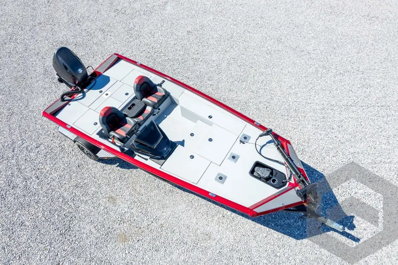 Slide: The Image of 2026 Vexus Defender 189 boat, aerial view, red and gray design, parked on gravel. - 53