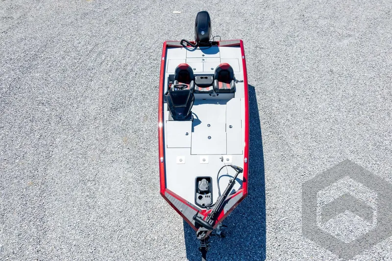 Slide: The Image of 2026 Vexus Defender 189 boat, aerial view, red and gray design on gravel surface. - 54