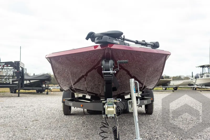 Slide: The Image of 2026 Vexus Defender 189 boat on trailer, front view, parked on gravel lot. - 6