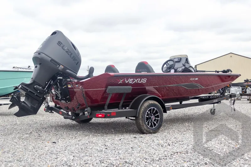 Slide: The Image of 2026 Vexus Defender 189 boat with Suzuki engine on trailer, parked on gravel. - 9