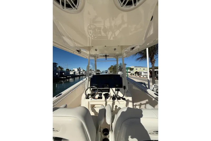 Slide: The Image of 2022 Cobia 320 Center Console boat interior with steering wheel and controls. - 17