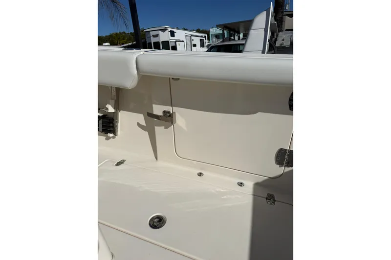 Slide: The Image of 2022 Cobia 320 Center Console boat interior detail with storage compartment and seating. - 31