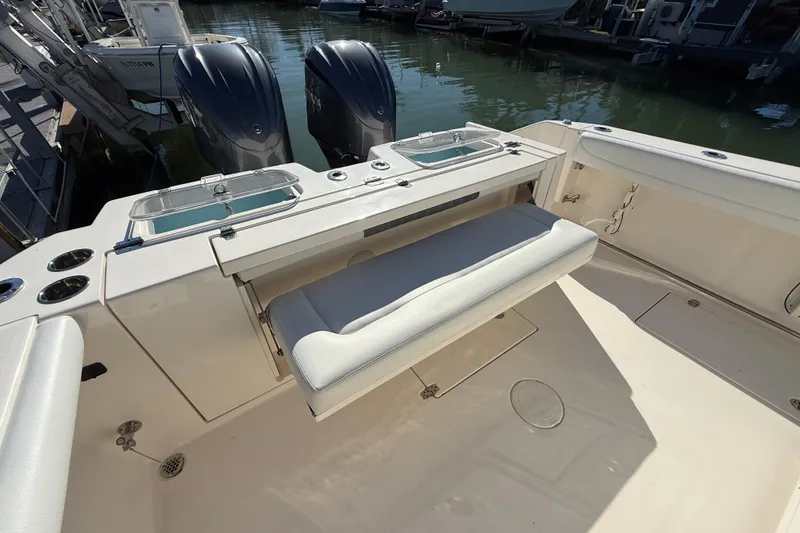 Slide: The Image of 2022 Cobia 320 Center Console boat with dual engines and seating area. - 9