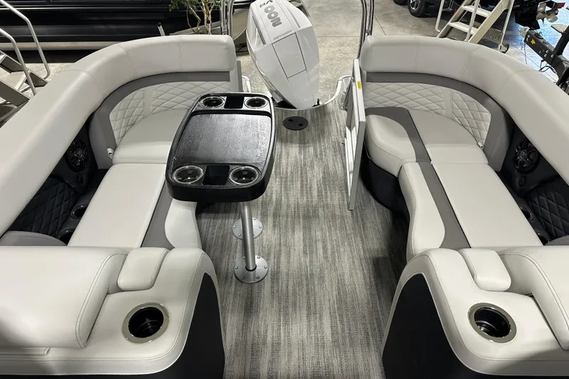 Slide: The Image of Open storage compartment in 2026 Godfrey MC 235 SBC boat, containing a cardboard box. - 13