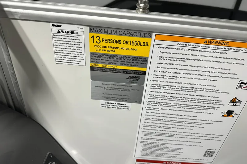 Slide: The Image of 2026 Godfrey MC 235 SBC capacity label, 13 persons or 1860 lbs, safety warnings included. - 15