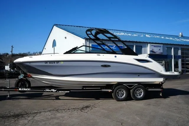 Slide: The Image of 2021 Sea Ray SDX 250 boat on trailer outside a building, clear blue sky. - 1