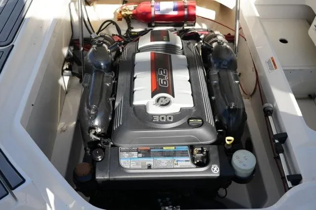 Slide: The Image of 2021 Sea Ray SDX 250 engine compartment with 6.2L engine and fire extinguisher. - 19