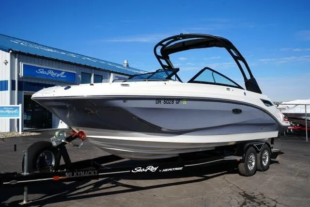 Slide: The Image of 2021 Sea Ray SDX 250 boat on trailer outside dealership. - 2