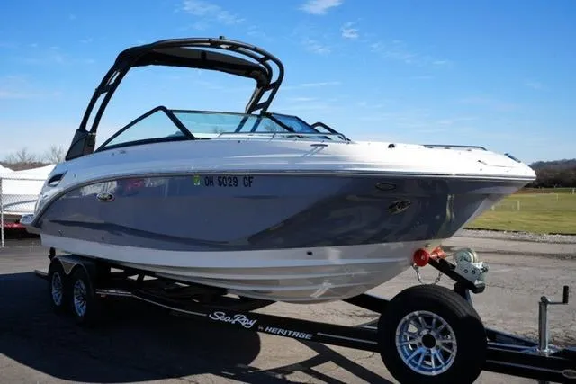 Slide: The Image of 2021 Sea Ray SDX 250 boat on trailer, sleek design, parked outdoors. - 3