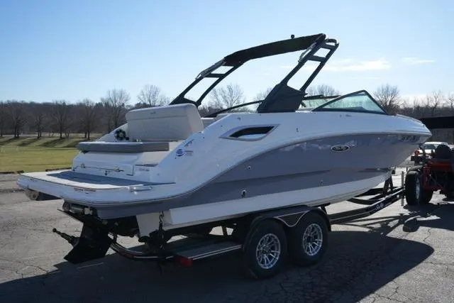 Slide: The Image of 2021 Sea Ray SDX 250 boat on trailer, parked outdoors under clear sky. - 5