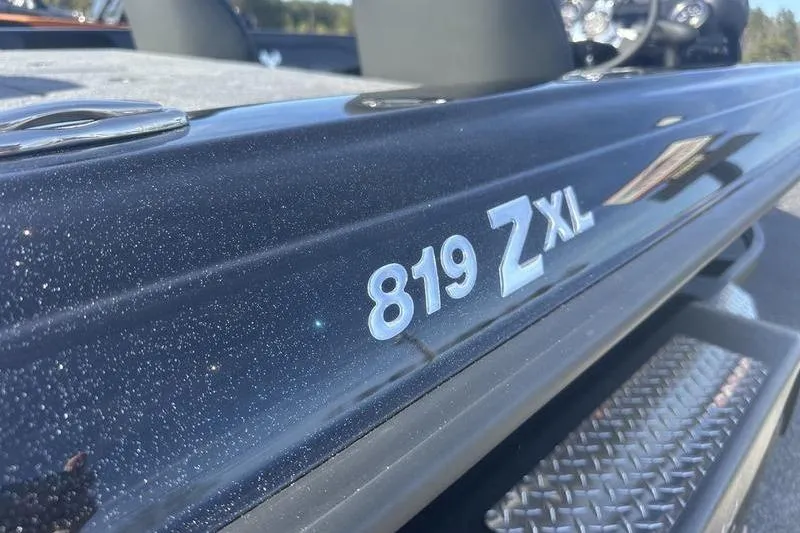 Slide: The Image of 2026 Phoenix 819 ZXL boat, close-up of model name on sleek black surface. - 4