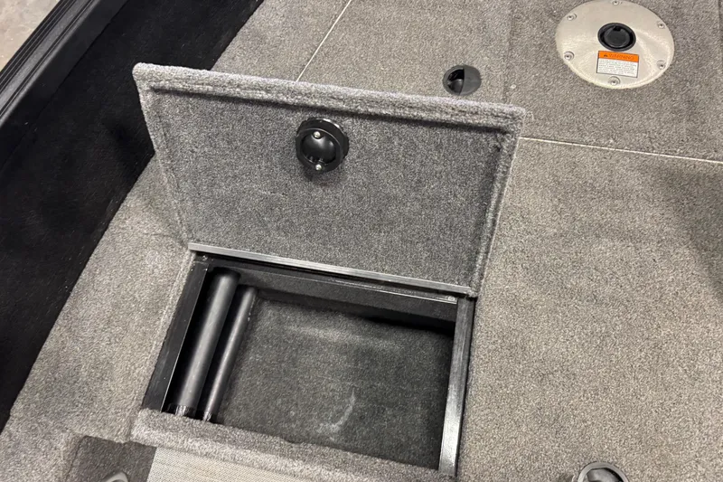 Slide: The Image of 2020 Alumacraft Competitor 165 Tiller boat storage compartment with open lid. - 11