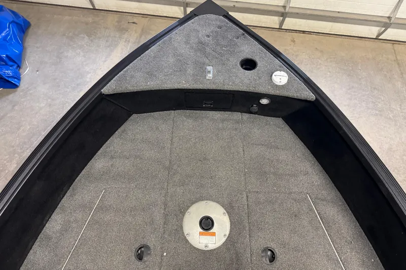 Slide: The Image of 2020 Alumacraft Competitor 165 Tiller boat interior with carpeted deck and storage compartments. - 14