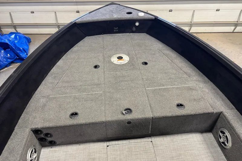 Slide: The Image of 2020 Alumacraft Competitor 165 Tiller boat interior with gray carpeted deck. - 8