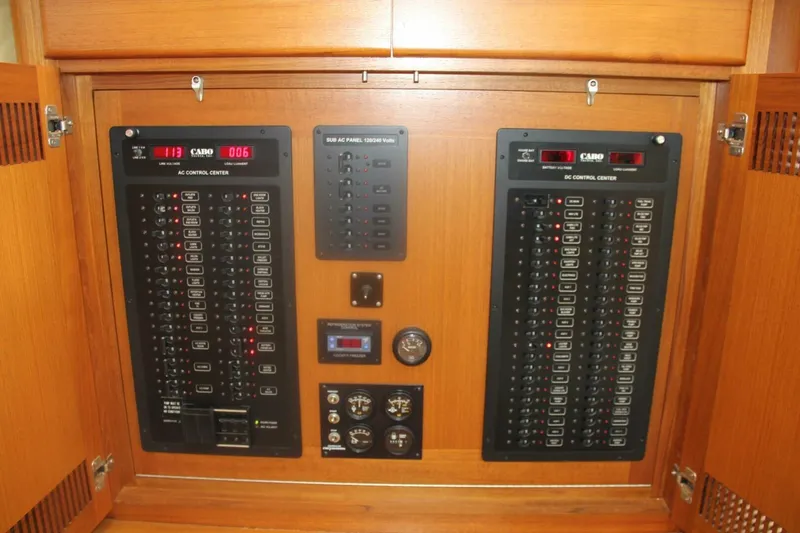 Slide: The Image of Electrical control panel of a 2004 Cabo 48 Flybridge yacht, featuring AC and DC systems. - 12