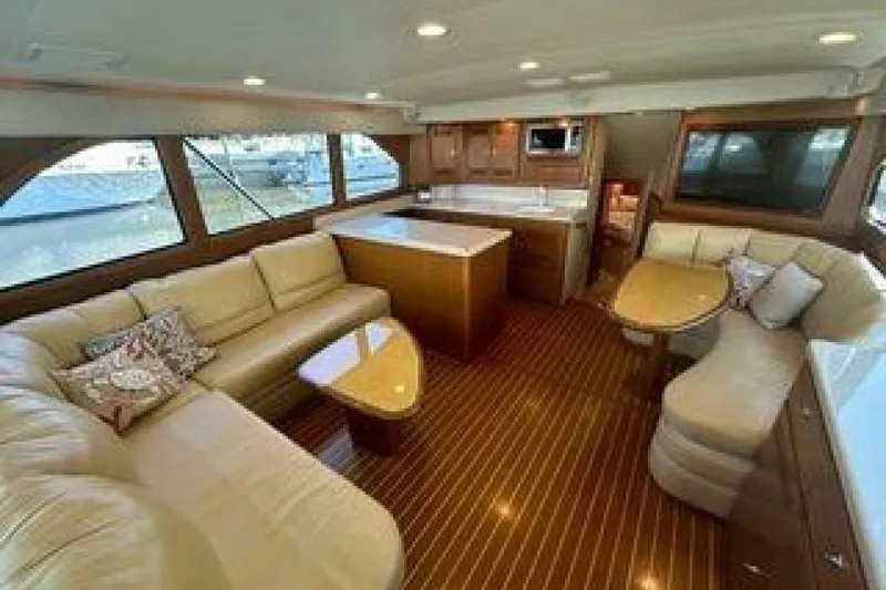 Slide: The Image of Luxurious interior of 2004 Cabo 48 Flybridge yacht with elegant seating and wooden finishes. - 2