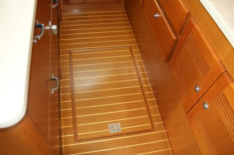 Slide: The Image of 2004 Cabo 48 Flybridge interior with wooden flooring and cabinetry. - 20