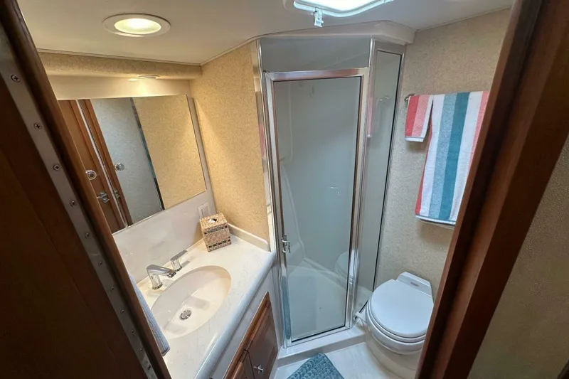 Slide: The Image of Luxurious bathroom in 2004 Cabo 48 Flybridge yacht with shower and modern amenities. - 38