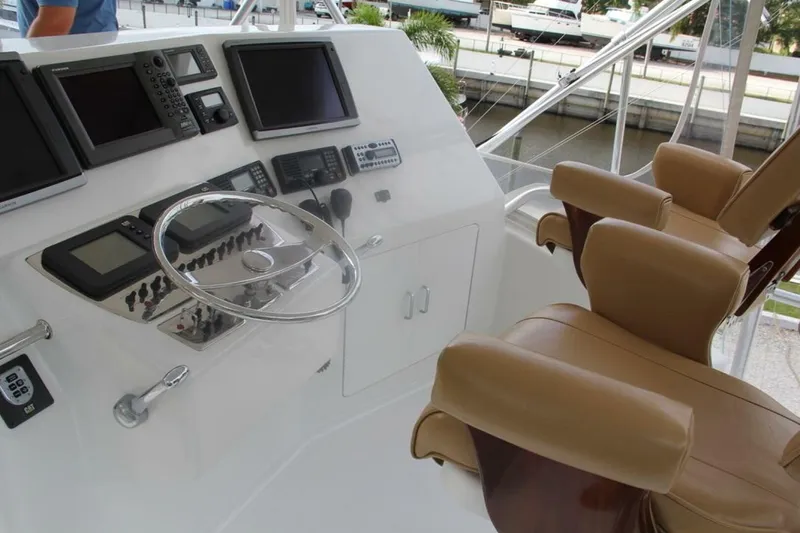 Slide: The Image of 2004 Cabo 48 Flybridge helm with advanced navigation systems and luxurious seating. - 4