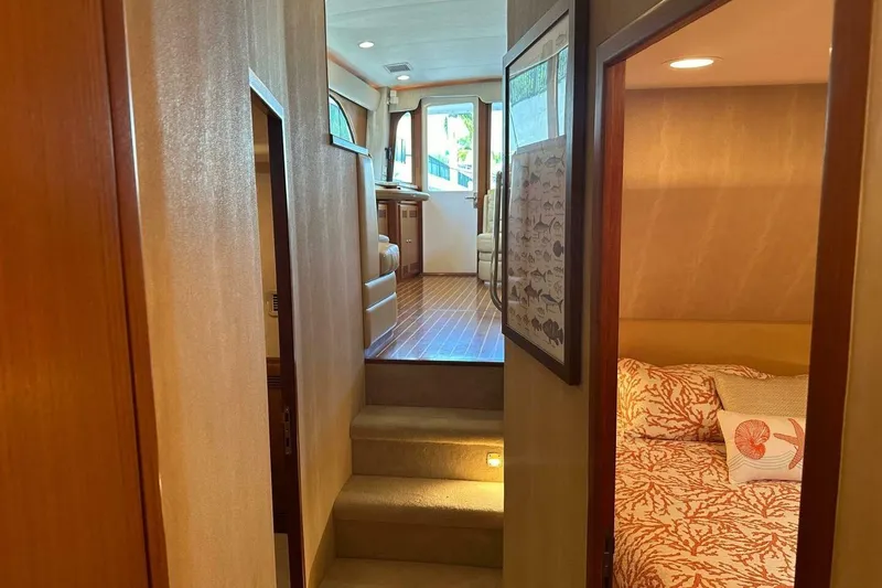 Slide: The Image of Interior of 2004 Cabo 48 Flybridge yacht, featuring cozy cabin and elegant wood finishes. - 41