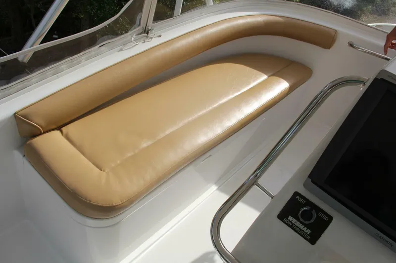 Slide: The Image of Beige seating on 2004 Cabo 48 Flybridge yacht with control panel. - 49