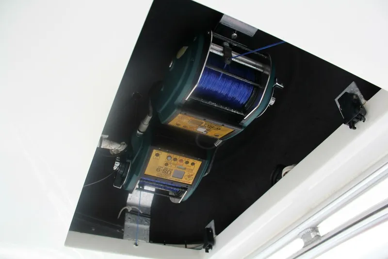 Slide: The Image of Fishing reel setup on 2004 Cabo 48 Flybridge boat, featuring blue line spools. - 50