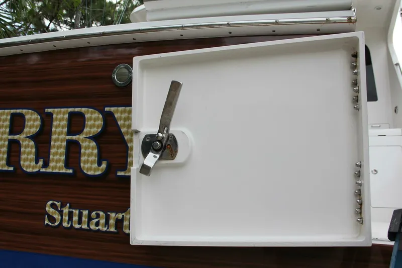 Slide: The Image of 2004 Cabo 48 Flybridge boat with open hatch and visible hardware. - 53