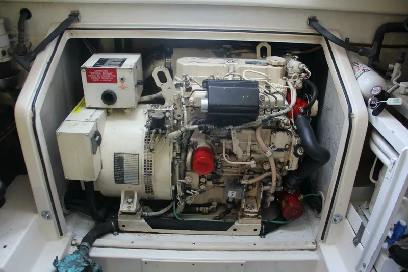 Slide: The Image of Engine compartment of a 2004 Cabo 48 Flybridge boat, showcasing detailed machinery. - 61